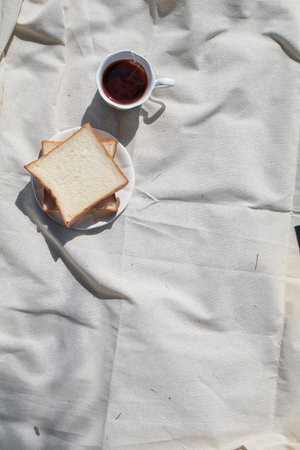 Coffee and bread on picnic blanket background relaxing on holiday. Still life concept. Copy space....