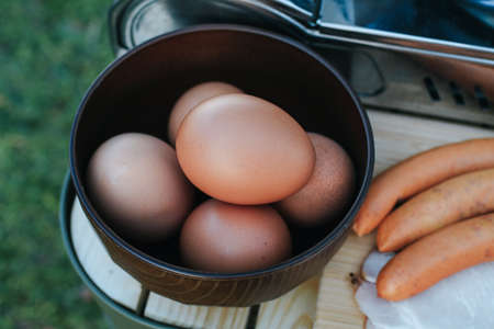 Organic Chicken eggs with sausage and ham for healthy breakfast on holiday.の写真素材
