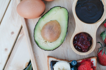 Avocado on wooden plate. Ripe fresh green avocado. Raw Fruits healthy green food.