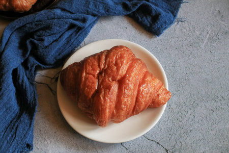 Freshly baked croissants on grey background. French and American Croissants and Baked Pastries are for breakfast.の写真素材