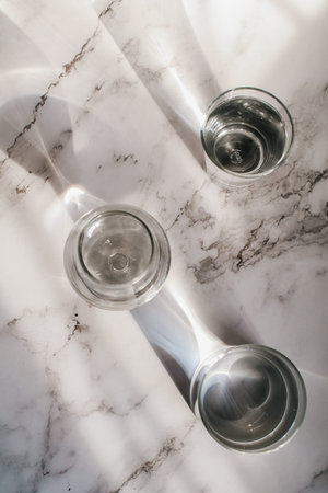 Sunlight through glass of water make light and shadow make a beautiful pattern by refraction of...