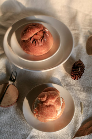 Homemade choux pastry with cream. on white background under sunlight. Selective focus, copy space....
