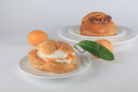 Delicious homemade choux pastry with custard and Marian Plum or Mayongchid. on white background