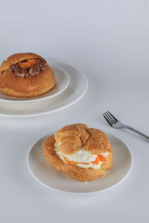 Delicious homemade choux pastry with custard and Marian Plum or Mayongchid. on white backgroundの写真素材