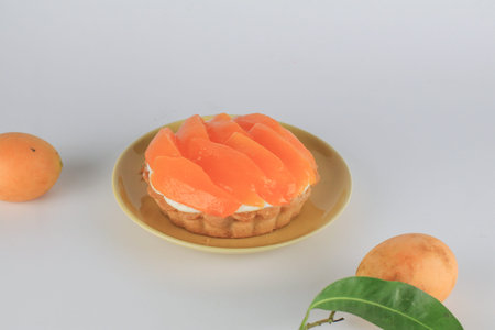 Mayongchid or marian plum cheese pie decorated with fresh plum mango. Homemade bakery concept with...