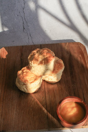 Scones serve with homemade currant jam under sunlight. Fresh yummy tasty delicious English pastry...