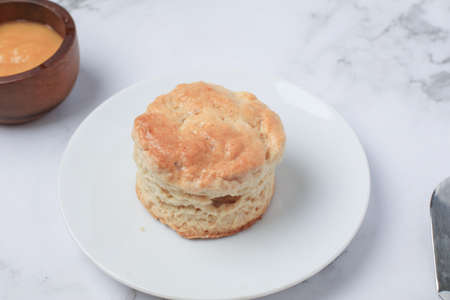 Homemade sweet scones on plate under morning sunlight. Fresh yummy tasty delicious English pastry for afternoonの写真素材
