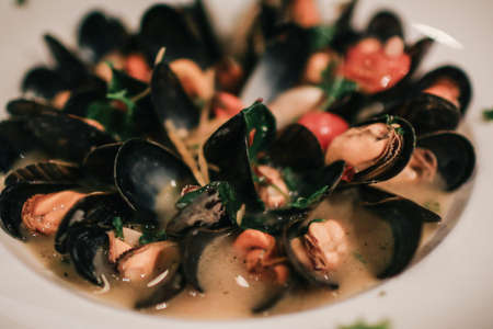Delicious healthy blue mussels in cream wine sauce. Italian traditional dinner food concept.の写真素材