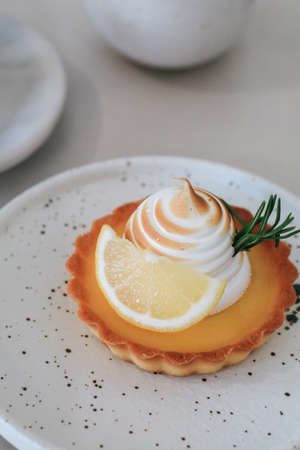Lemon meringue tart pastry with citrus fruits. Delicious, appetizing, homemade dessert with lemon curd cream.の写真素材