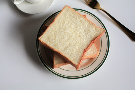 Slice Bread with hot coffee and marshmallow on white background.  Morning breakfast with coffee, butter and toasts.の写真素材