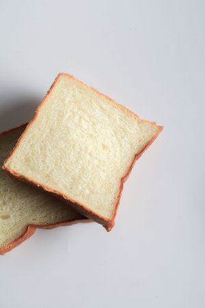 Homemade slide bread on white background. Morning breakfast concept. Fresh baked bread. Autumn tone...