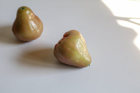 Freshly rose apple or Chomphu fruit on white background. The fruits are sweet and red or green.