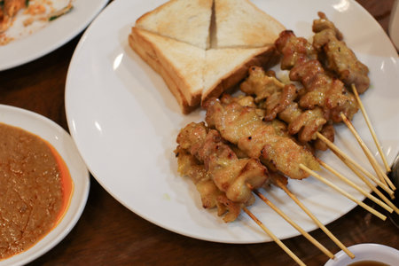 Pork Satay, Grilled pork served with peanut sauce or sweet and sour sauce. Thai street food that is delicious and popular among Thai people And tourists.の写真素材