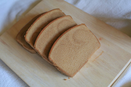 Homemade slice butter bread on wooden cutting board. Simple breakfast in the morning. Fresh bakery.