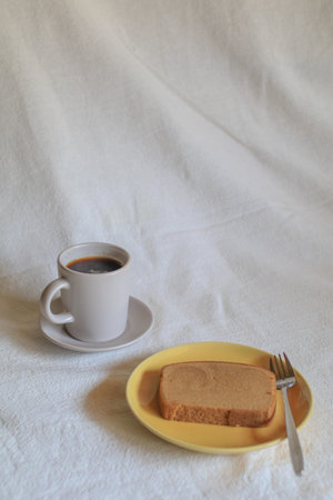 Hot coffee with butter bread on white background. Morning Breakfast concept. Minimal vintage tone....