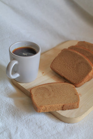 Hot coffee with butter bread on white background. Morning Breakfast concept. Minimal vintage tone....