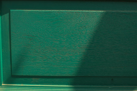 Dark green concrete wall background with sunlight. Old vintage grunge texture design. Abstract art wallpaper with copy spaceの写真素材