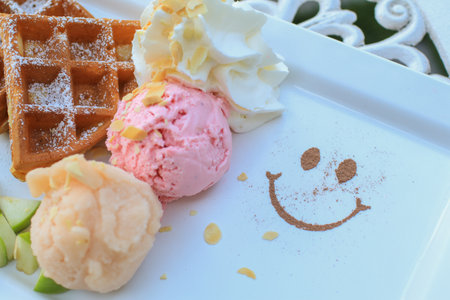 Waffles with apple and ice cream on white table.  Tasty sweet sugary waffles. Homemade dessert. Background with copy space.の写真素材