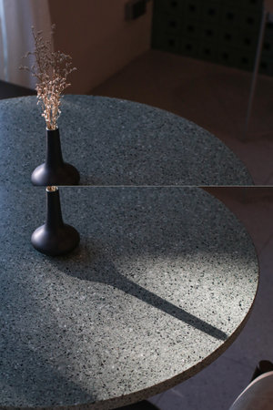 Dry grass bouquet flower in vase with warm shadows from sunlight on wooden table. Scandinavian vase on the table with copy space, minimal aesthetic styleの写真素材