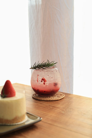 Mixed berry Mojito soda with strawberry cake and banana bread on wooden table with christmas tree....