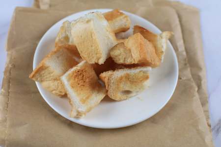 Sliced Toast bread white plate on vintage background.. Continental Breakfast concept.
