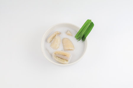 Banana in coconut milk (Kluay Buat Chi) on white background. Popular Traditional dessert of asian, Thailand.の写真素材