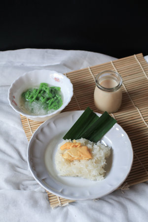 Asian Thai dessert, Sticky rice with durian in coconut milk and Lod Chong on table.の写真素材