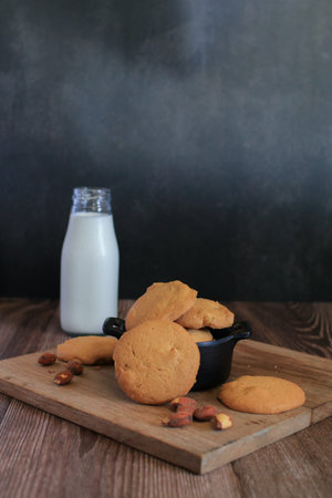Homemade cookie almond on wooden cutting board. Healthy food. Oatmeal biscuits. Vegan vegetarian...