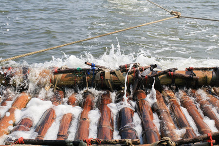 Traditional Enjoy bamboo Rafting on water. Sustainable nature material. Transportation, Travel...