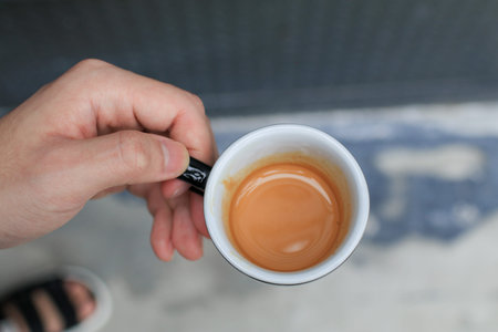 Man holding cup of hot coffee espresso. Breakfast beverage morning concept. Light atmosphere, on...