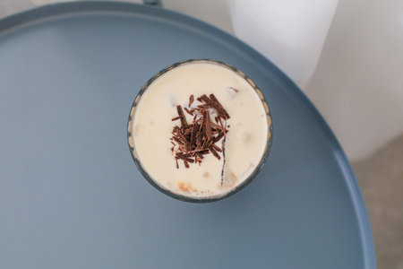 Irish coffee with cream on table in cafe. Tasty delicious coffee drink in morning breakfast.の写真素材