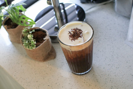 Irish coffee with cream on table in cafe. Tasty delicious festive coffee drink in morning breakfast.