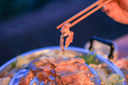 Thai BBQ grill pork in dim light on mountain camp ground. Traditional Thai style BBQの写真素材