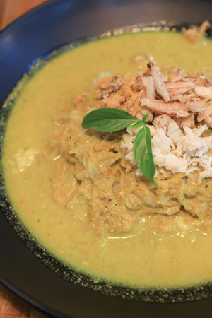 Kanom jeen gaeng pu , Chinese rice noodles with crab curry, rich yellow curry with generous chunks of fresh white crab meat and basil.の写真素材