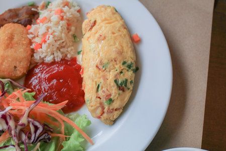 Healthy Omlette American breakfast with fried rice and ketchup on white plate. Traditional delicious morning meal.の写真素材
