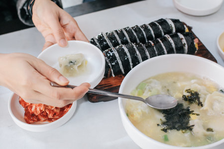 Homemade delicious dumpling Soup with seaweed egg drop soup in white bowl eat with kimbub. Asian foodの写真素材