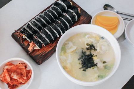 Homemade delicious dumpling Soup with seaweed egg drop soup in white bowl eat with kimbub. Asian foodの写真素材