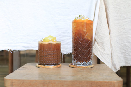 Tropical iced lemonade coffee on wooden table. Homemade cold summer Refreshing healthy drink.