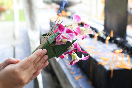 Orchid bouquet with Incense and candle for worshiping Buddha. Thai Buddhistsâ respect to Buddhism.の写真素材