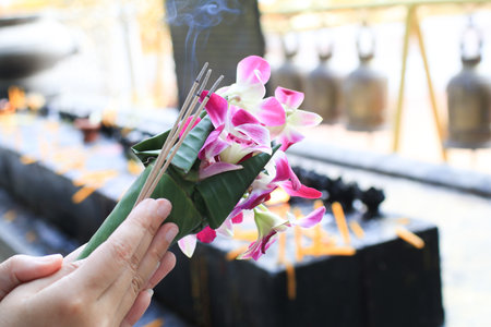 Orchid bouquet with Incense and candle for worshiping Buddha. Thai Buddhistsâ respect to Buddhism.の写真素材