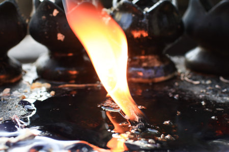 Candles lit on oil in temple creates spiritual and peaceful atmosphere. Buddhist ceremony and Paying...