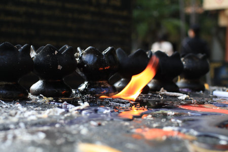 Candles lit on oil in temple creates spiritual and peaceful atmosphere. Buddhist ceremony and Paying respect to Buddha.の写真素材