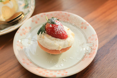 Donut with strawberry and cream on cute luxury plate with vintage style. Freshly homemade baked.