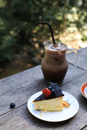 Cheesecake with blueberry and strawberry on top. Delicious homemade pastry on wooden table.の写真素材