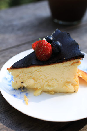 Cheesecake with blueberry and strawberry on top. Delicious homemade pastry on wooden table.の写真素材