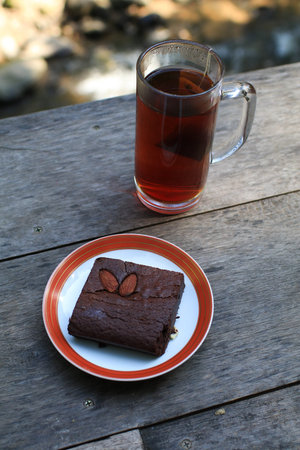 Delicious chocolate brownies with almond on wooden table. Homemade sweet dessert baking.の写真素材