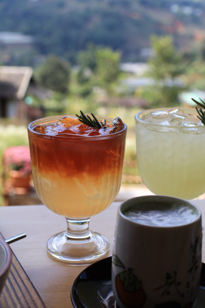 Iced americano black coffee with orange juice. Trendy summer refreshing drink.の写真素材