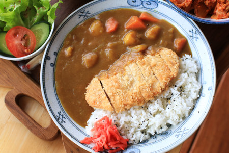 Fried pork cutlet curry with rice in beautiful plate. Popular Japanese food lunch set.の写真素材