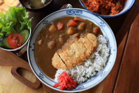 Fried pork cutlet curry with rice in beautiful plate. Popular Japanese food lunch set.の写真素材