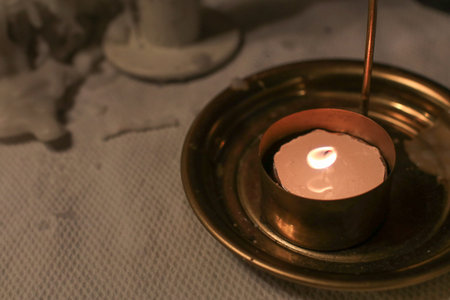 Candlelight on dinner table in Restaurant. Romantic Dinner or wedding atmosphere. Cozy night.の写真素材